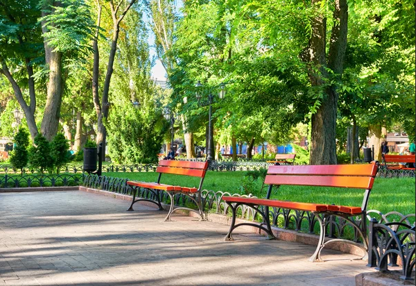 Two park benches in a park.